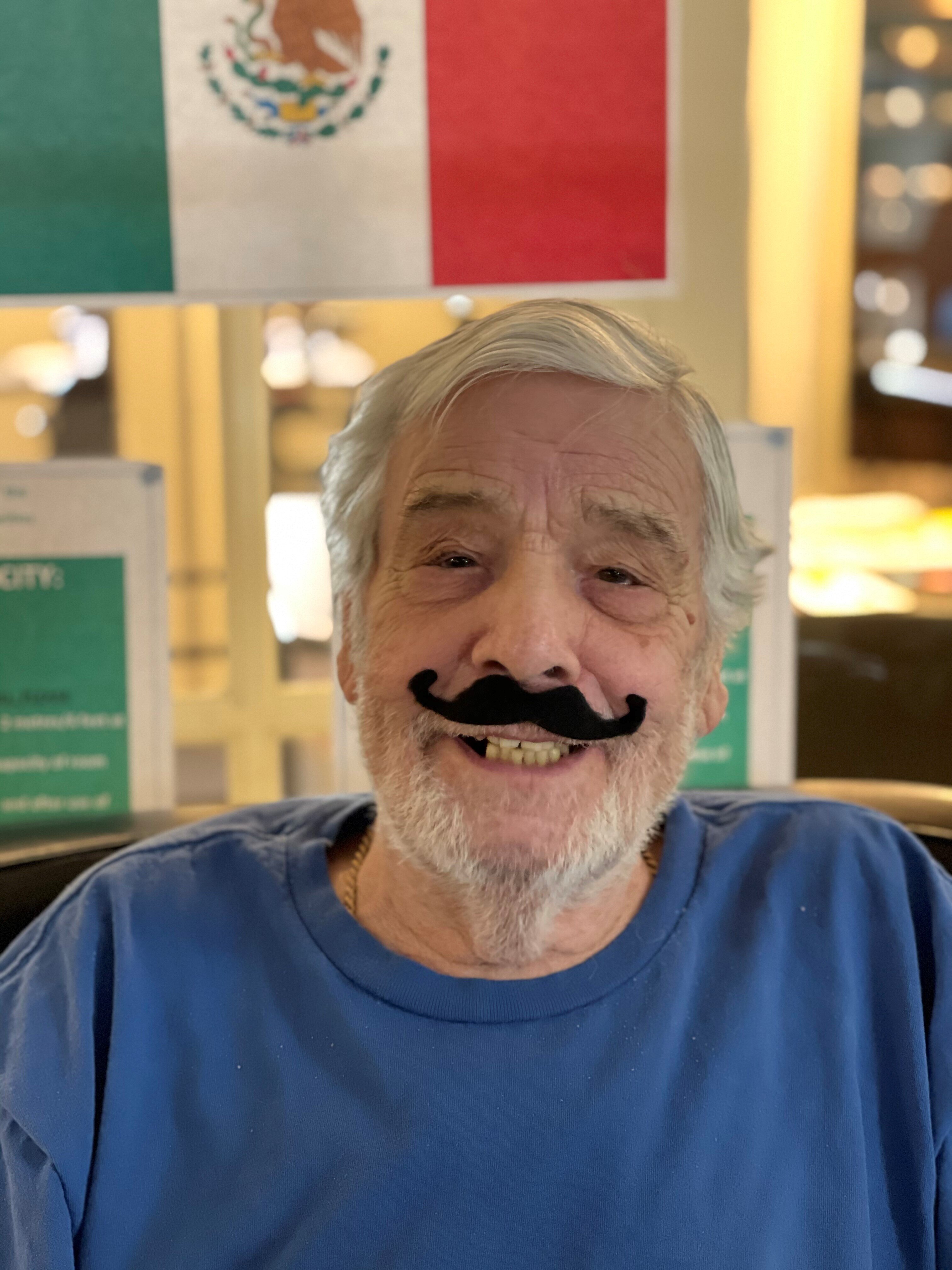 A senior man celebrating Cinco De Mayo in senior housing
