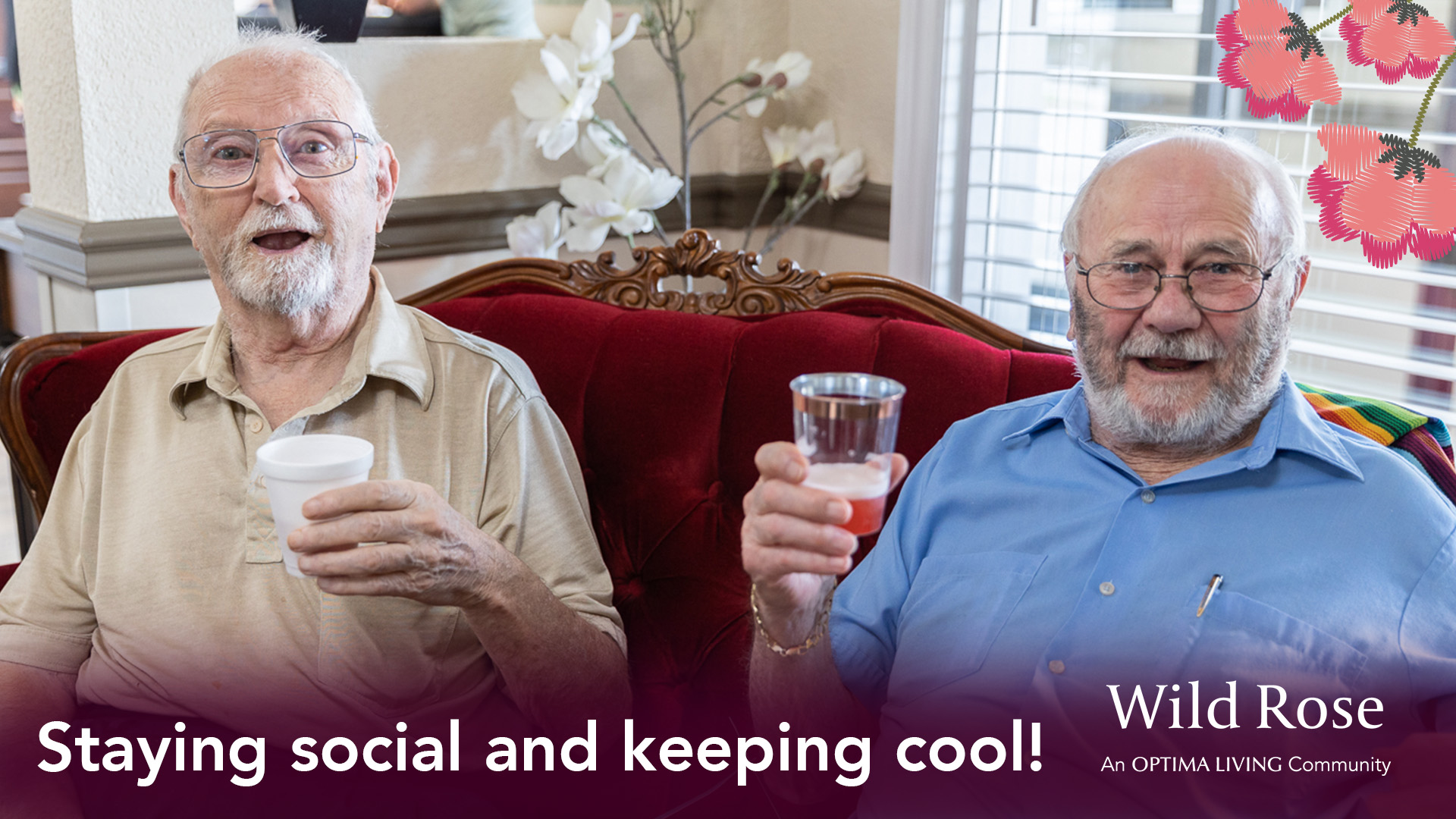Two seniors sitting together enjoying some drinks and smiling.