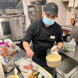 A picture of a chef preparing breakfast for a senior living community