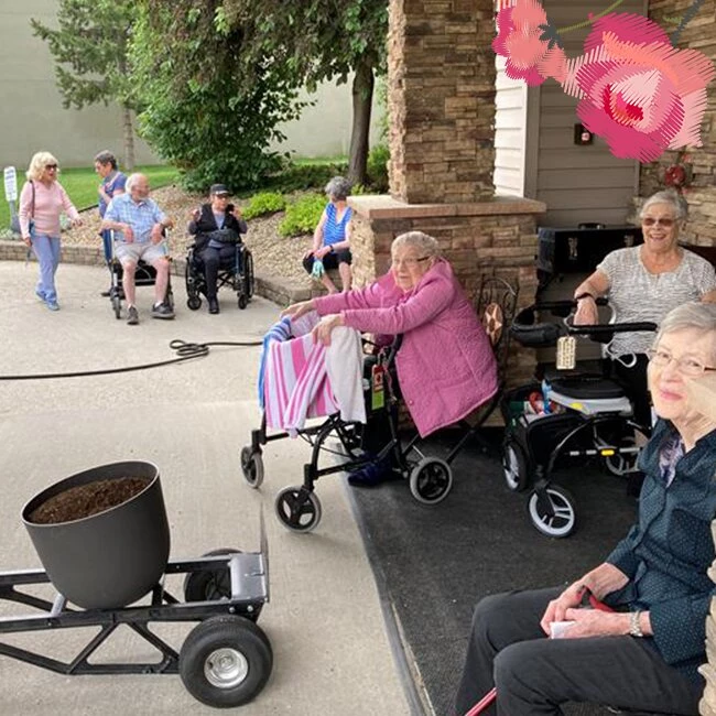 A gathering of senior citizens sitting in the garden and enjoying independent living for seniors on site