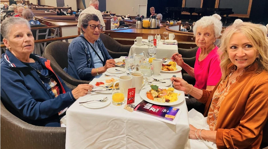More residents enjoying a healthy meal for seniors together at the Mayfield Dinner Theatre.