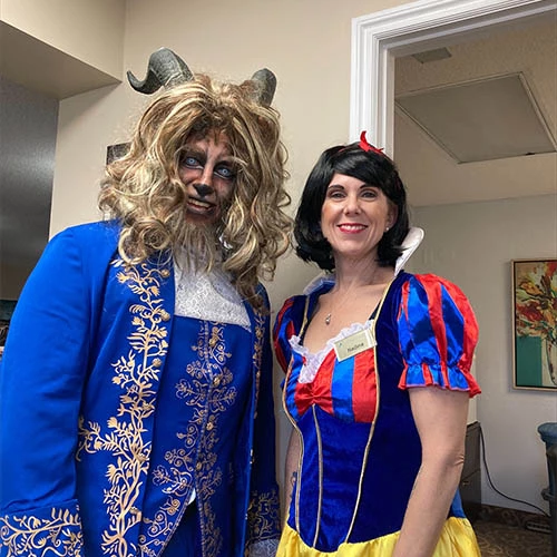 The Beast from Beauty and the Beast along with Snow White dressed for halloween in a retirement home