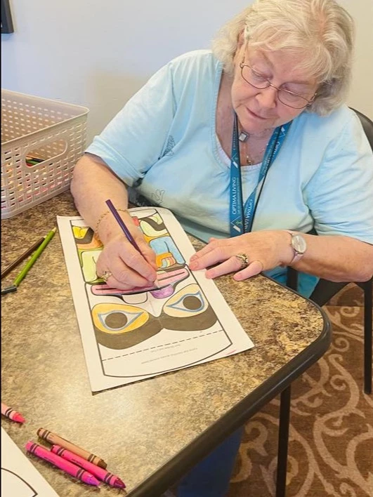 Resident finishing her colouring page for Truth and Reconciliation Day.