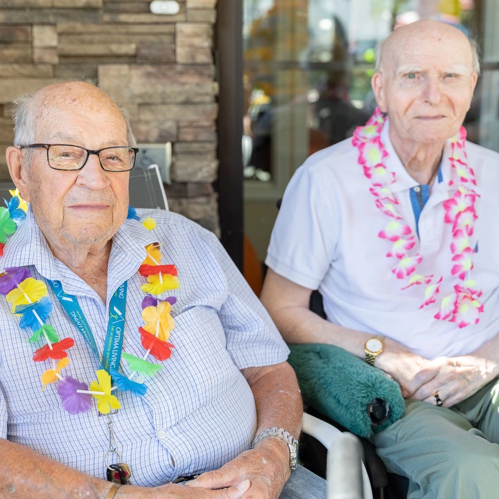 Some Wild Rose senior living residents in Hawaiian Lei's enjoying the event together.