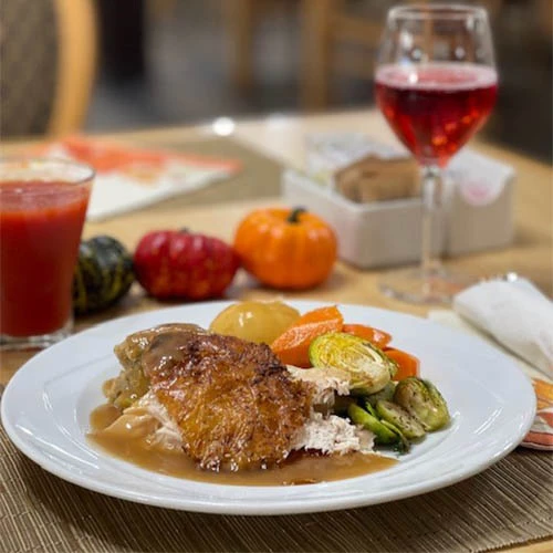 Thanksgiving dinner with turkey, gravy and vegetables. Healthy meals for seniors.