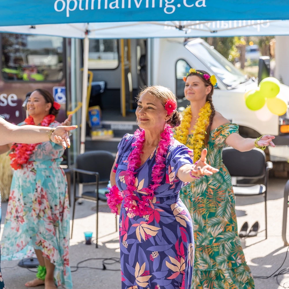 Some ladies dancing at an event outside a retirement home